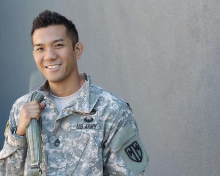 A smiling army veteran in uniform.